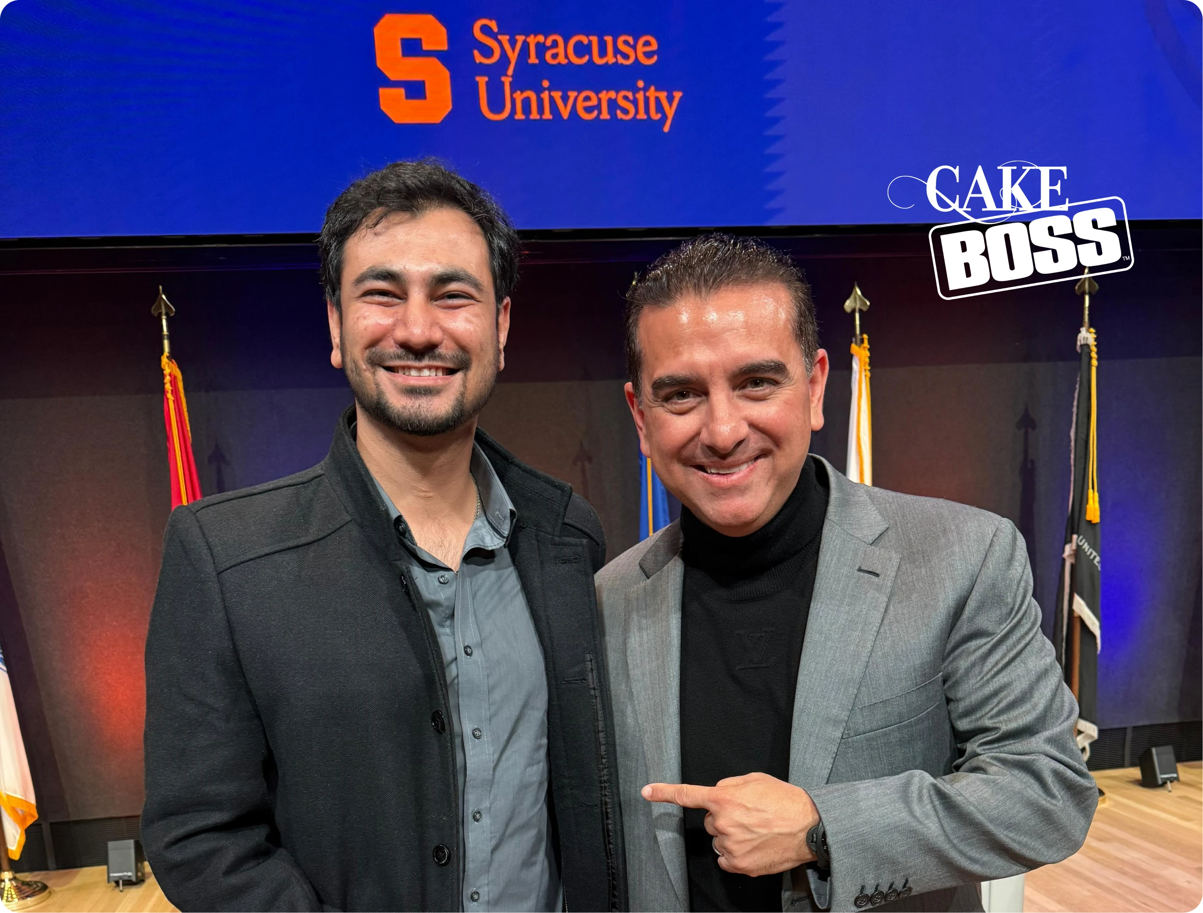 website design Two men in front of a screen with the Syracuse University logo